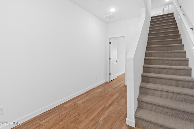 stairs featuring wood-type flooring