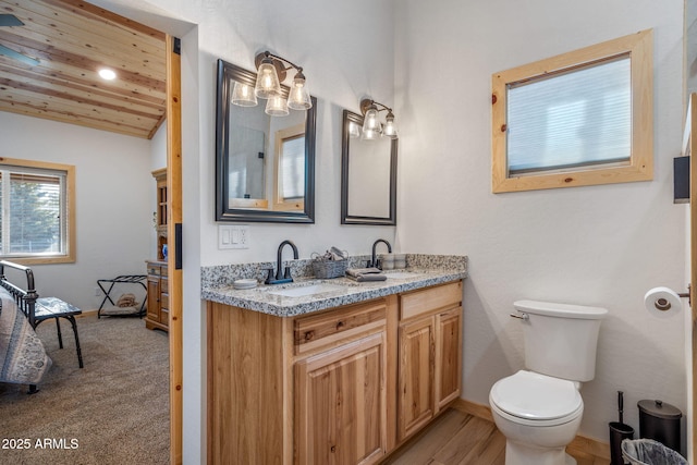 bathroom with vanity, vaulted ceiling, wood ceiling, and toilet