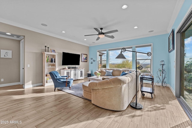 living room featuring ornamental molding, light hardwood / wood-style floors, and ceiling fan