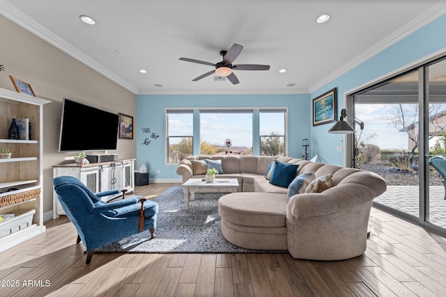 living room with crown molding, ceiling fan, and light wood-type flooring