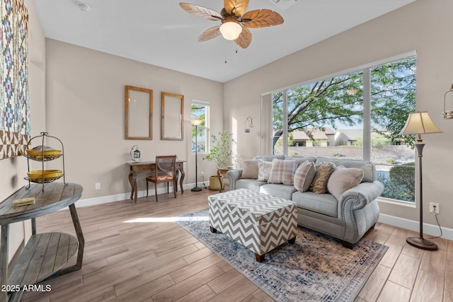 living room featuring ceiling fan and light wood-type flooring