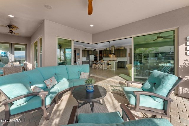 living room with light hardwood / wood-style floors and ceiling fan