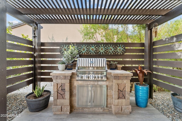 view of patio with exterior kitchen, grilling area, and a pergola