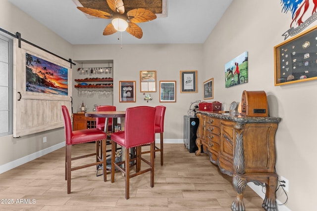 dining area featuring ceiling fan and light wood-type flooring