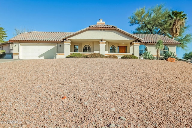 mediterranean / spanish-style home featuring a garage