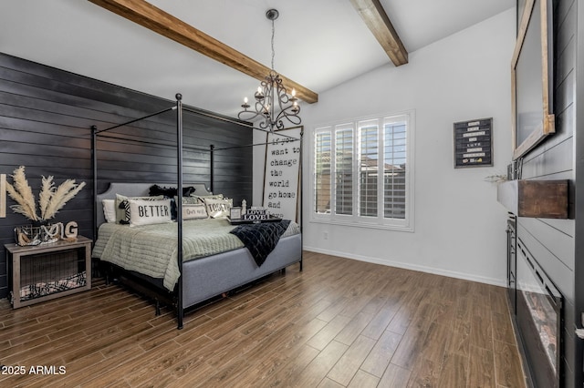 bedroom with a notable chandelier, vaulted ceiling with beams, baseboards, and wood finished floors