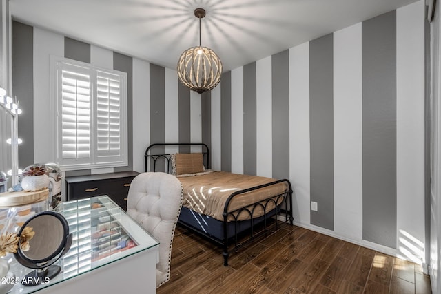 bedroom with baseboards, dark wood-type flooring, and wallpapered walls