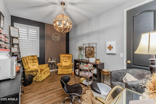 living area featuring an inviting chandelier and wood finished floors