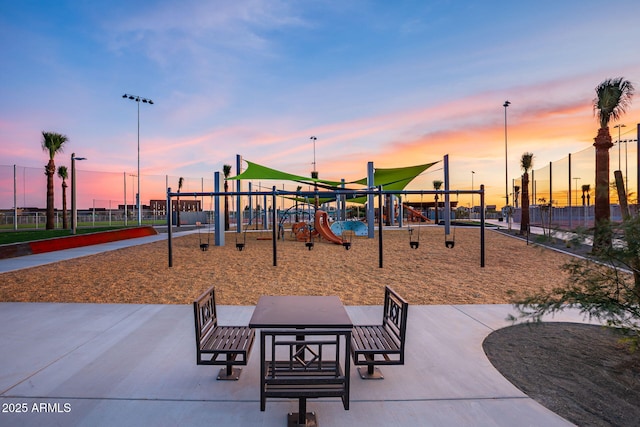 view of community featuring playground community and fence