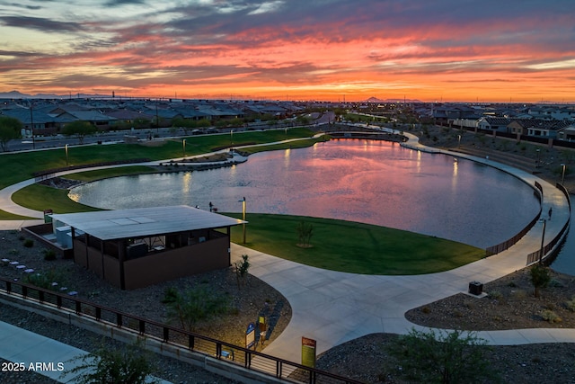 pool at dusk featuring a residential view