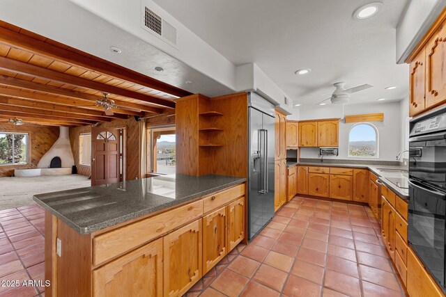 651 Chaparral Rd, Wickenburg, AZ 85390 - kitchen with ceiling fan, plenty of natural light, visible vents, stainless steel built in fridge, and a peninsula