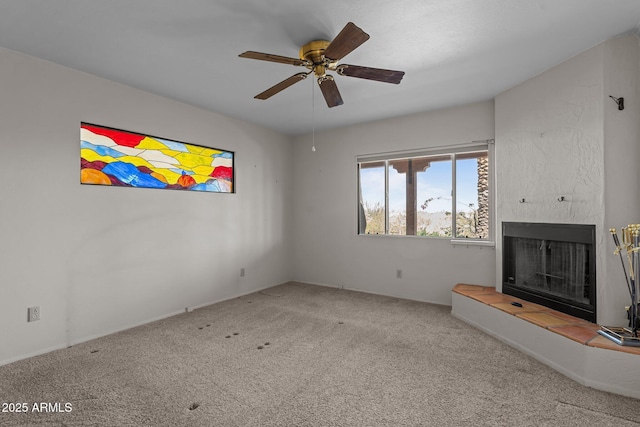651 Chaparral Rd, Wickenburg, AZ 85390 - unfurnished living room featuring carpet flooring, ceiling fan, and a large fireplace