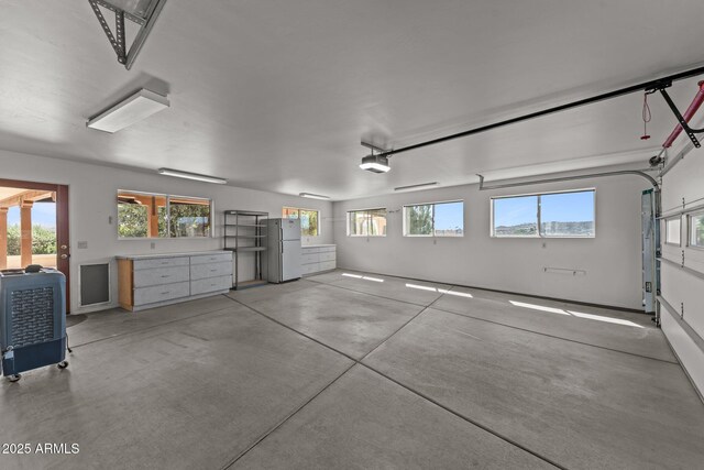 651 Chaparral Rd, Wickenburg, AZ 85390 - garage with freestanding refrigerator and a garage door opener