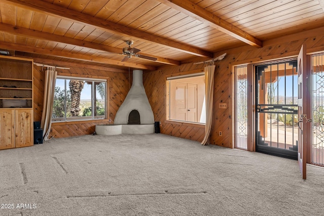 651 Chaparral Rd, Wickenburg, AZ 85390 - unfurnished living room featuring wooden walls, ceiling fan, carpet, beamed ceiling, and wood ceiling