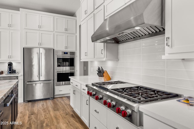 16134 E Ridgestone Dr, Fountain Hills, AZ 85268 - kitchen with appliances with stainless steel finishes, ventilation hood, light countertops, backsplash, and white cabinetry