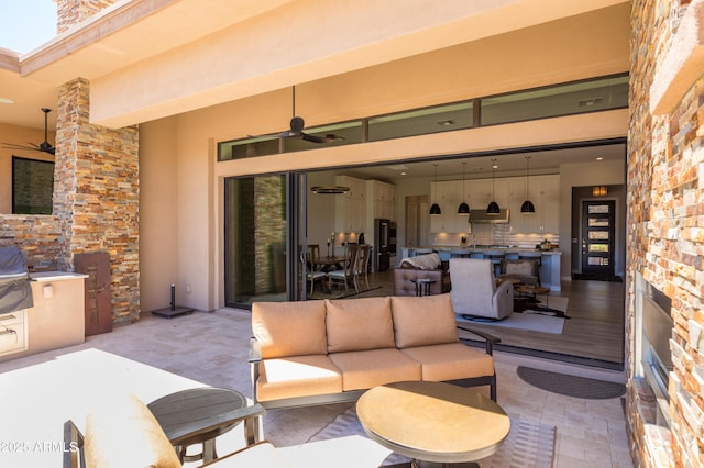 16134 E Ridgestone Dr, Fountain Hills, AZ 85268 - view of patio with ceiling fan, an outdoor living space, and an outdoor kitchen