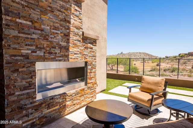 16134 E Ridgestone Dr, Fountain Hills, AZ 85268 - view of patio / terrace featuring an outdoor stone fireplace and a mountain view