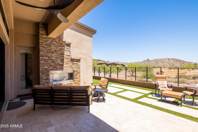 16134 E Ridgestone Dr, Fountain Hills, AZ 85268 - view of patio with a mountain view, ceiling fan, and an outdoor living space with a fireplace
