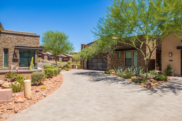 16134 E Ridgestone Dr, Fountain Hills, AZ 85268 - view of front of house with stone siding, decorative driveway, an attached garage, and stucco siding