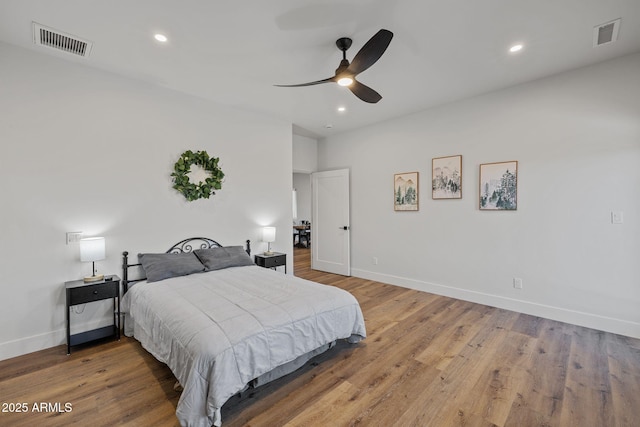 bedroom with hardwood / wood-style floors and ceiling fan