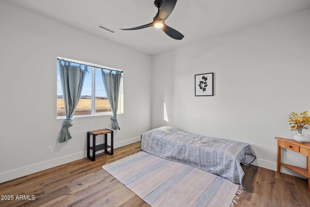 bedroom with ceiling fan and light wood-type flooring