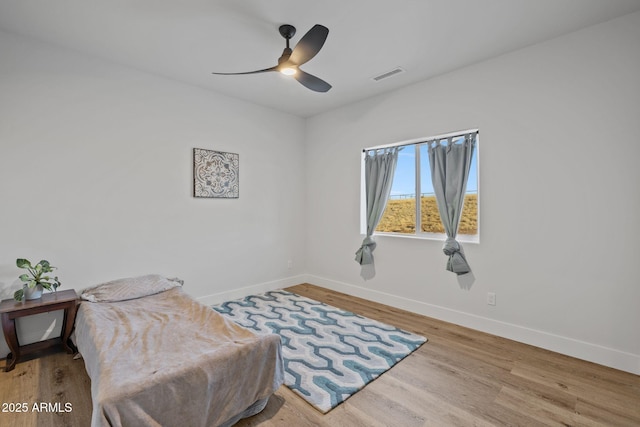 sitting room with light hardwood / wood-style floors and ceiling fan