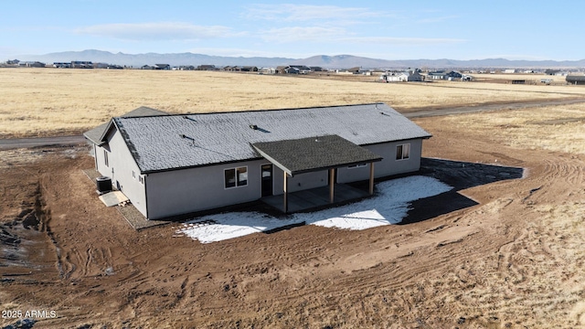 birds eye view of property with a mountain view