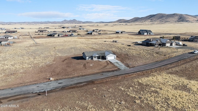 drone / aerial view featuring a mountain view and a rural view