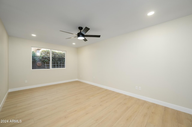 empty room featuring ceiling fan and light hardwood / wood-style flooring