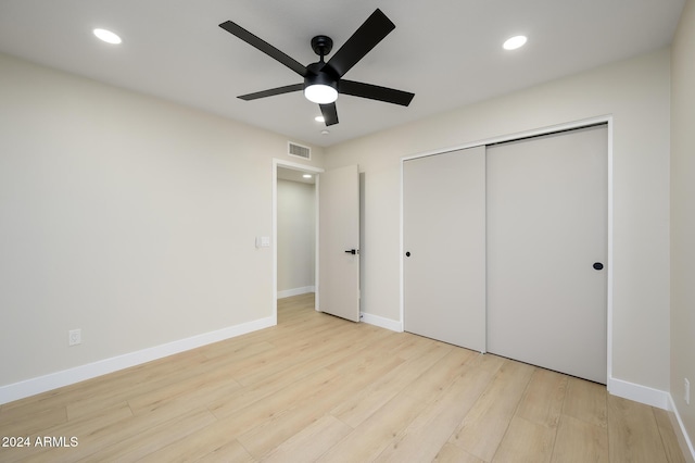 unfurnished bedroom with light hardwood / wood-style floors, a closet, and ceiling fan