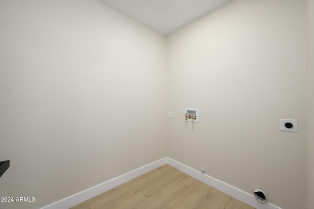 clothes washing area featuring hookup for an electric dryer, hardwood / wood-style flooring, washer hookup, and hookup for a gas dryer