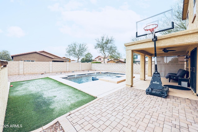 view of swimming pool with ceiling fan, a fire pit, and a patio