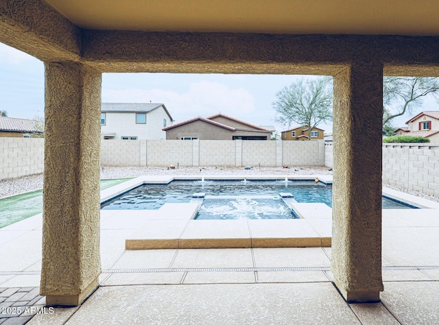 view of swimming pool with an in ground hot tub