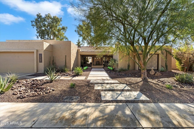 southwest-style home featuring a garage