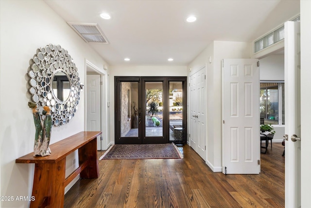 foyer entrance with dark wood-type flooring and french doors