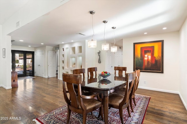 dining space featuring dark hardwood / wood-style floors and french doors