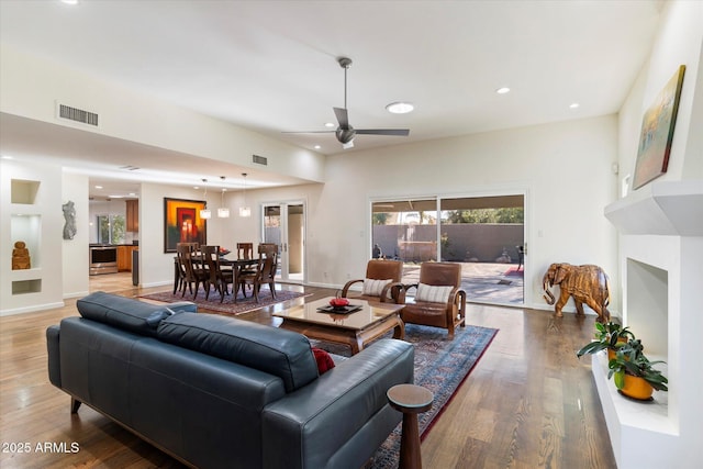 living room featuring ceiling fan and hardwood / wood-style floors