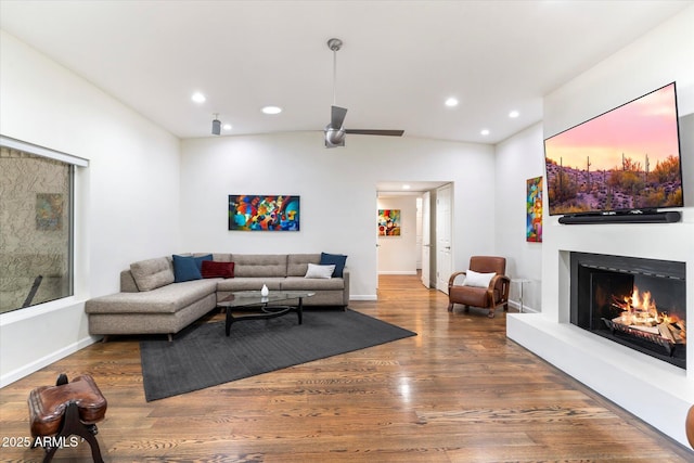 living room featuring ceiling fan and dark hardwood / wood-style flooring