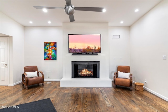 sitting room with ceiling fan and dark hardwood / wood-style flooring