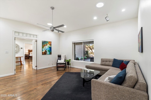 living room with hardwood / wood-style flooring and ceiling fan