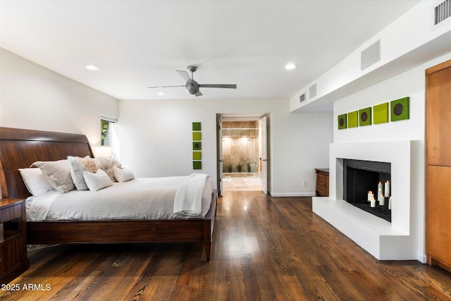 bedroom featuring ceiling fan, dark hardwood / wood-style floors, and ensuite bathroom