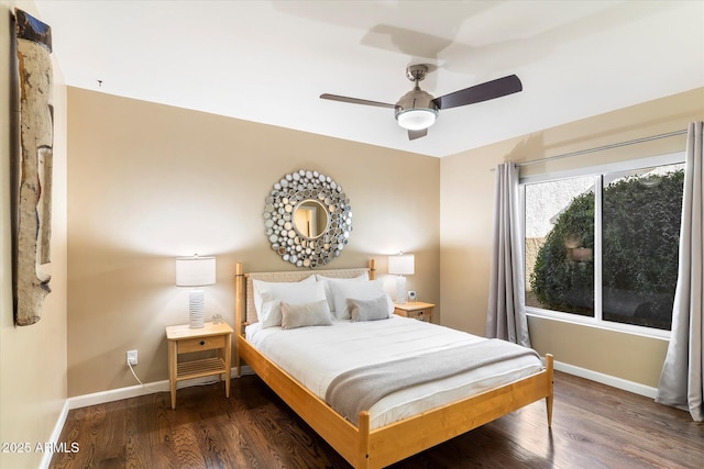 bedroom with ceiling fan and dark hardwood / wood-style floors