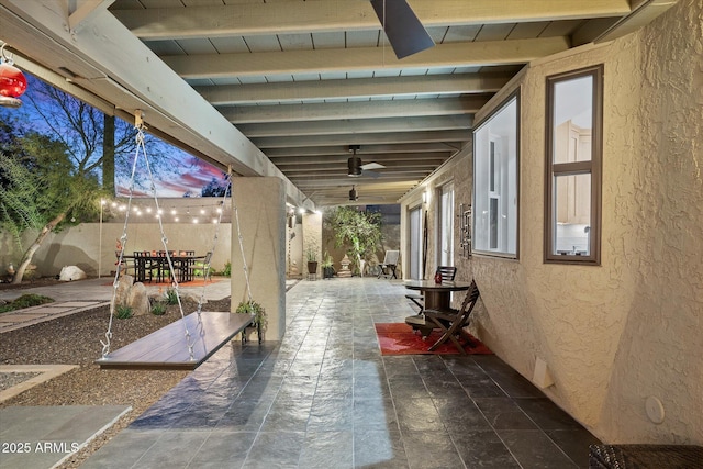 patio terrace at dusk with ceiling fan