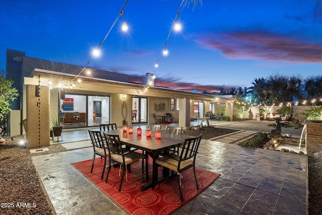 view of patio terrace at dusk