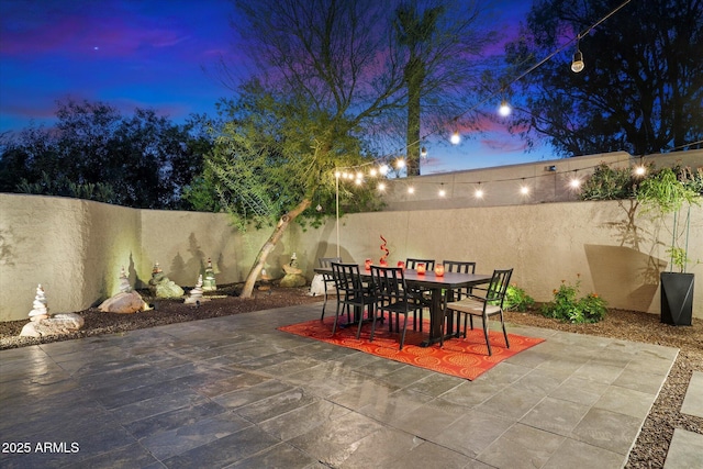 view of patio terrace at dusk