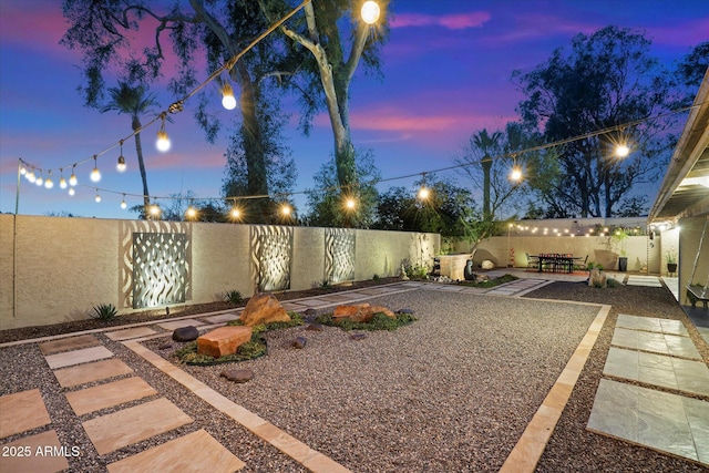 yard at dusk with a patio