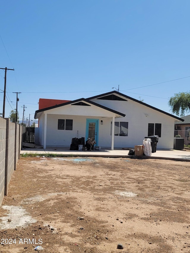 rear view of house featuring cooling unit and a patio