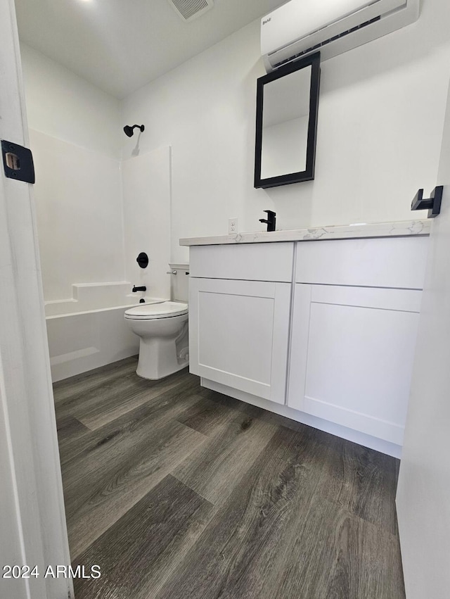 full bathroom featuring hardwood / wood-style floors, vanity, shower / bathing tub combination, and a wall mounted AC