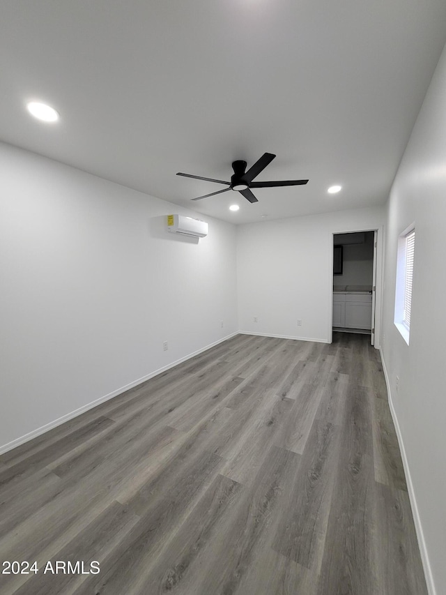 2002 W Adams St, Phoenix, AZ 85009 - empty room with recessed lighting, wood finished floors, a ceiling fan, a wall mounted AC, and baseboards