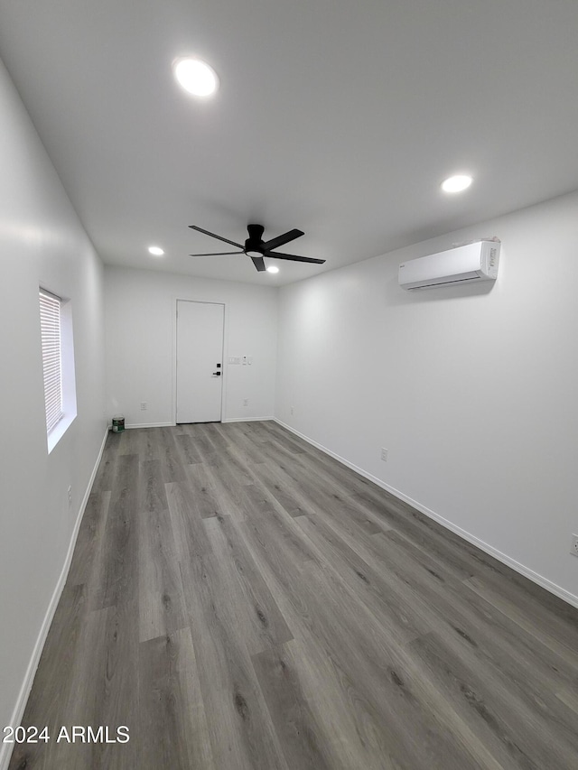 2002 W Adams St, Phoenix, AZ 85009 - basement with a wall mounted air conditioner, recessed lighting, a ceiling fan, wood finished floors, and baseboards